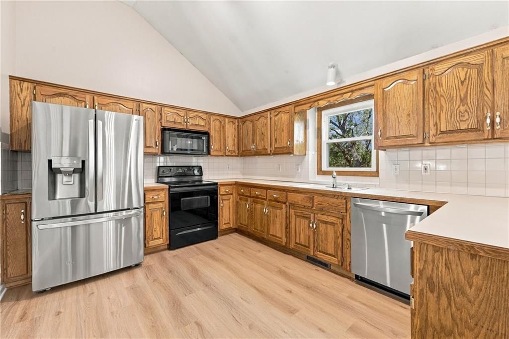 Kitchen backsplash and mixed-finish hardware at 9504 NW 87th Terrace, Kansas City, MO 64153