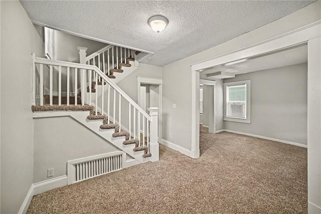 Staircase, wood stair railing and white trim at 1603 Elmwood Street, Kansas City, MO 64127