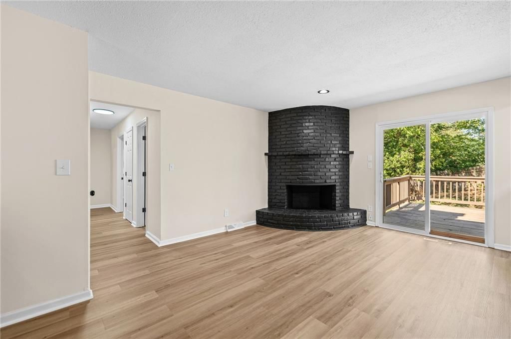 Fireplace, deck and luxury vinyl floors at 14710 NW 67th Street, Parkville, MO 64152