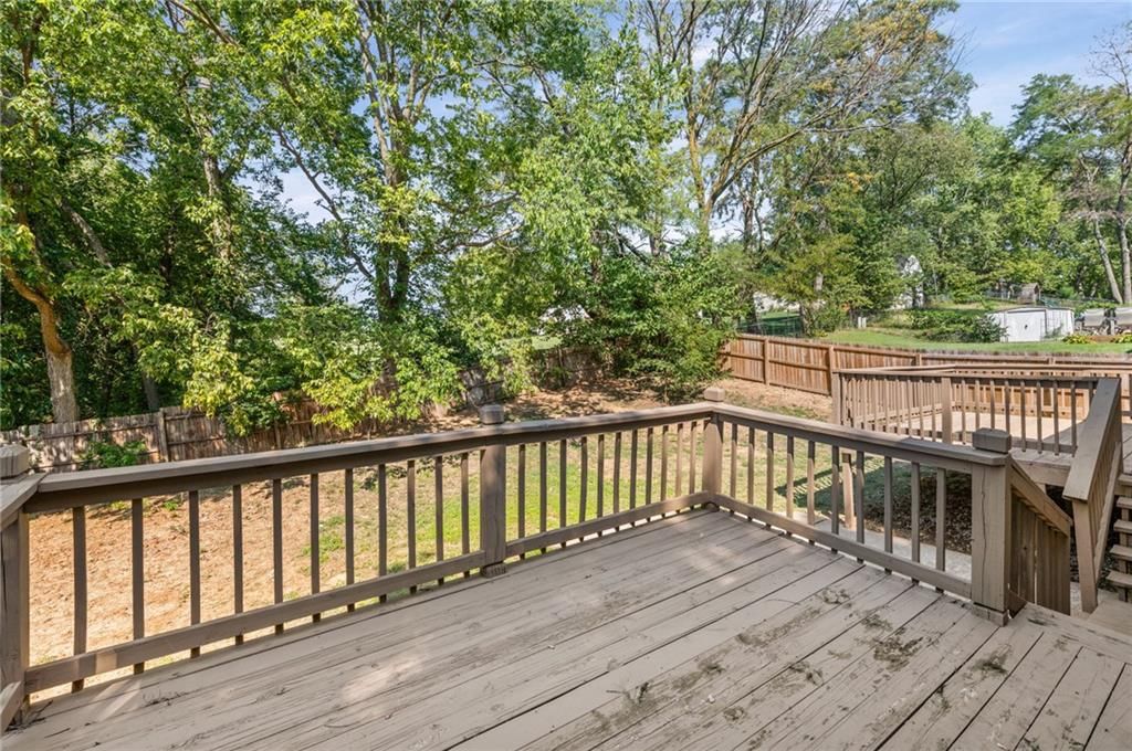 Fenced yard, mature trees and wood fence at 14710 NW 67th Street, Parkville, MO 64152