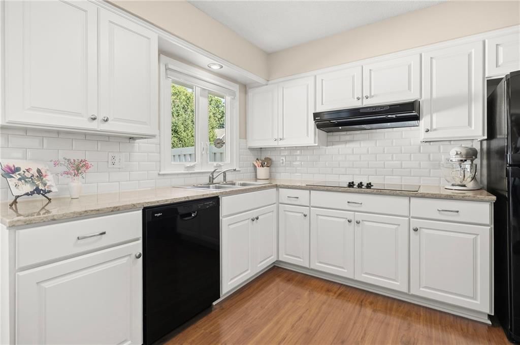 White kitchen, electric range and kitchen backsplash at 7812 W 100th Terrace, Overland Park, KS 66212