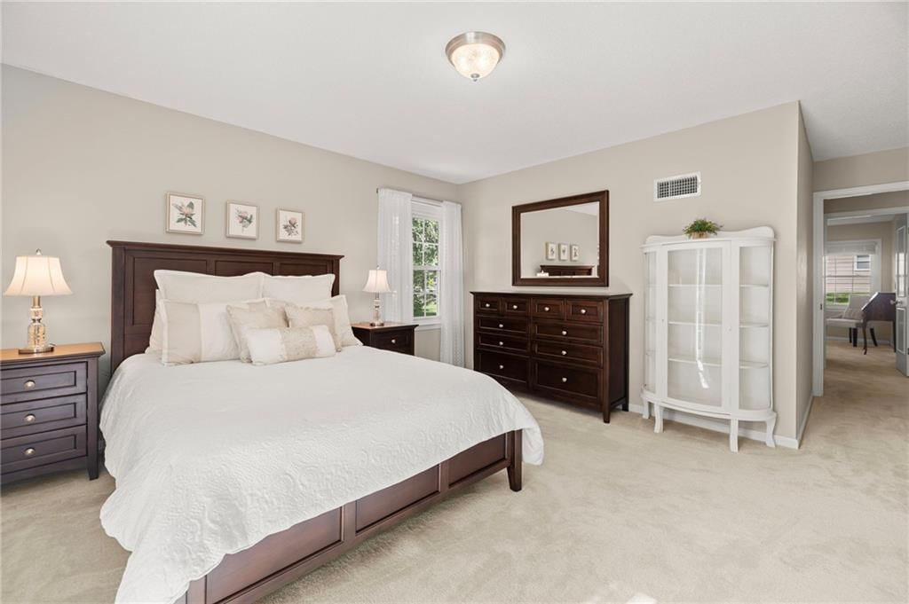 Main-floor primary bedroom at 7812 W 100th Terrace, Overland Park, KS 66212