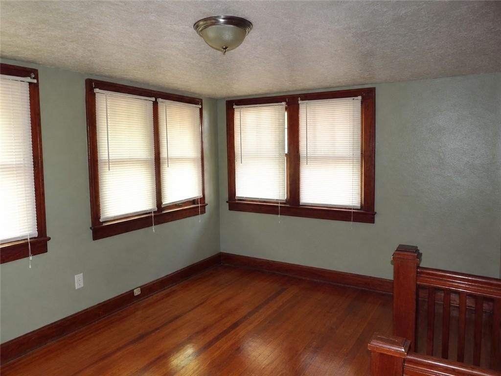Hardwood floors, staircase and wood stair railing at 340 Elmwood Avenue, Kansas City, MO 64124