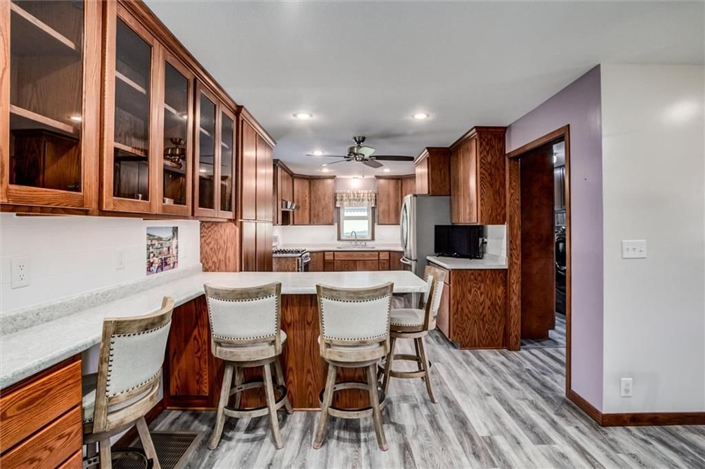 Kitchen island, luxury vinyl floors and breakfast nook at 1904 4th Street, Platte City, MO 64079