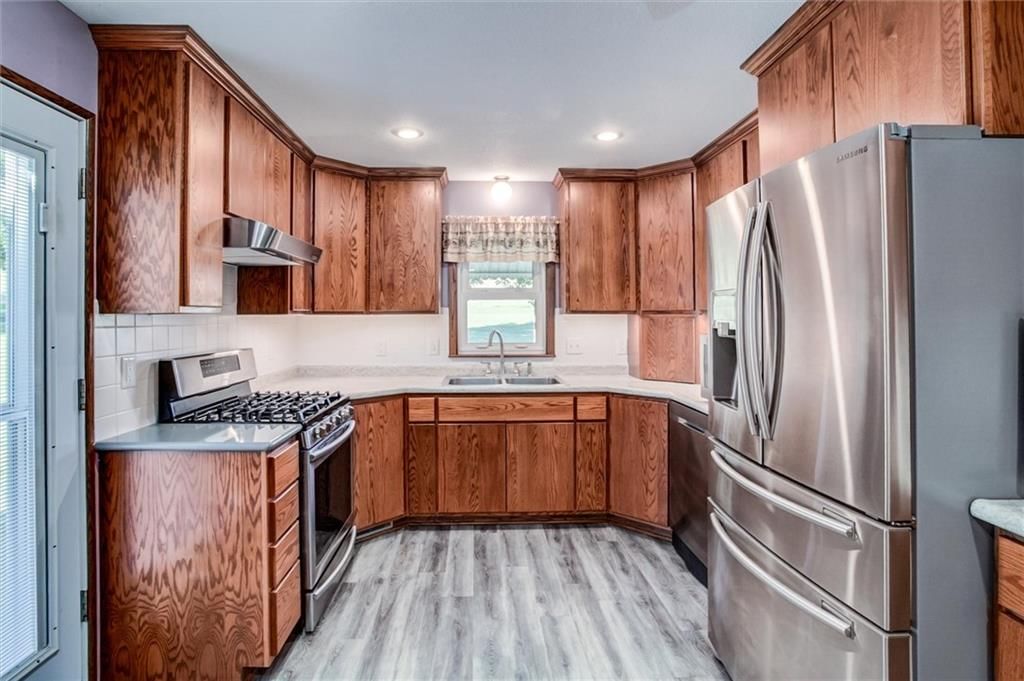 Gas range, stainless steel appliances and kitchen backsplash at 1904 4th Street, Platte City, MO 64079