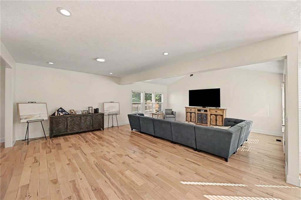 Open floor plan, hardwood floors and recessed lighting at 20831 W 102nd Street, Lenexa, KS 66220