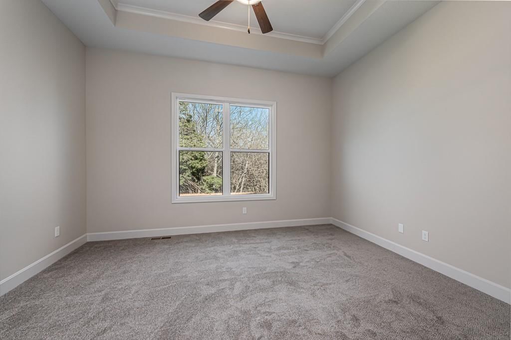 Main-floor primary bedroom and carpet at 15627 Austin Court, Basehor, KS 66007