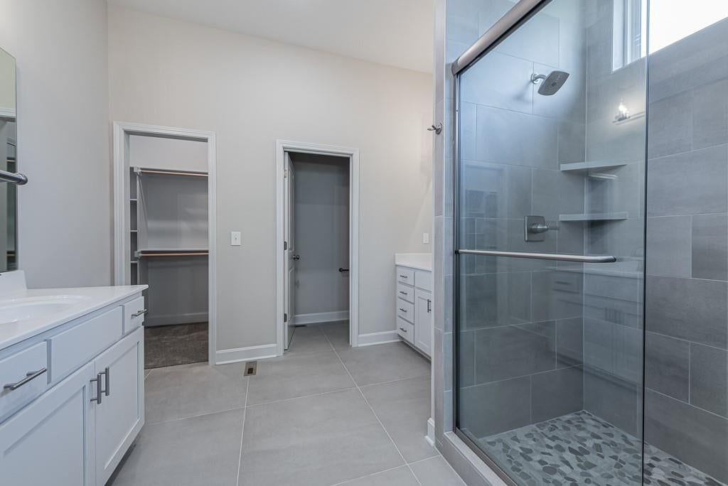 Tile floors, walk-in shower and private toilet room at 15627 Austin Court, Basehor, KS 66007