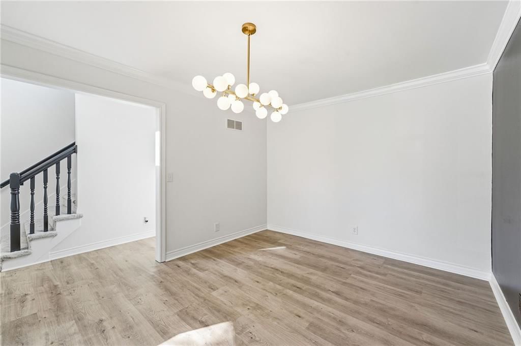 Statement lighting, staircase and black hardware at 1436 N Anne Shirley Drive, Olathe, KS 66061