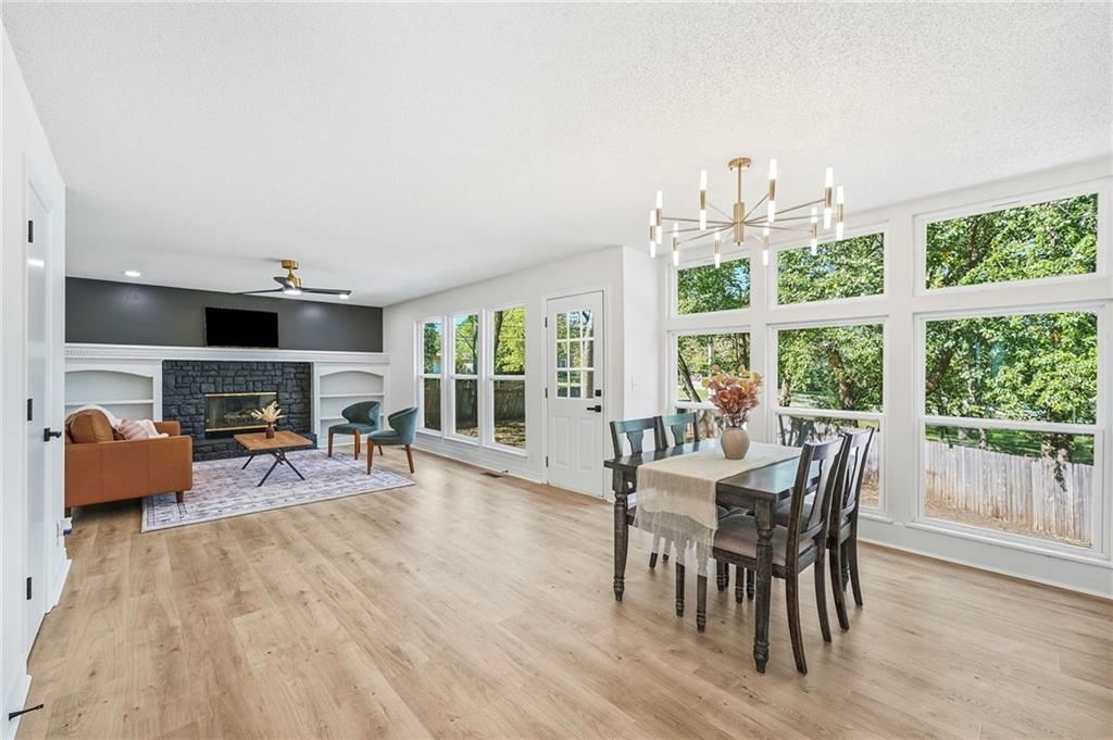 Fireplace, open floor plan and wall of windows at 1436 N Anne Shirley Drive, Olathe, KS 66061