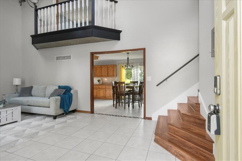 Tile floors, staircase and wood stair railing at 1628 NE AUBURN Drive, Lee's Summit, MO 64086