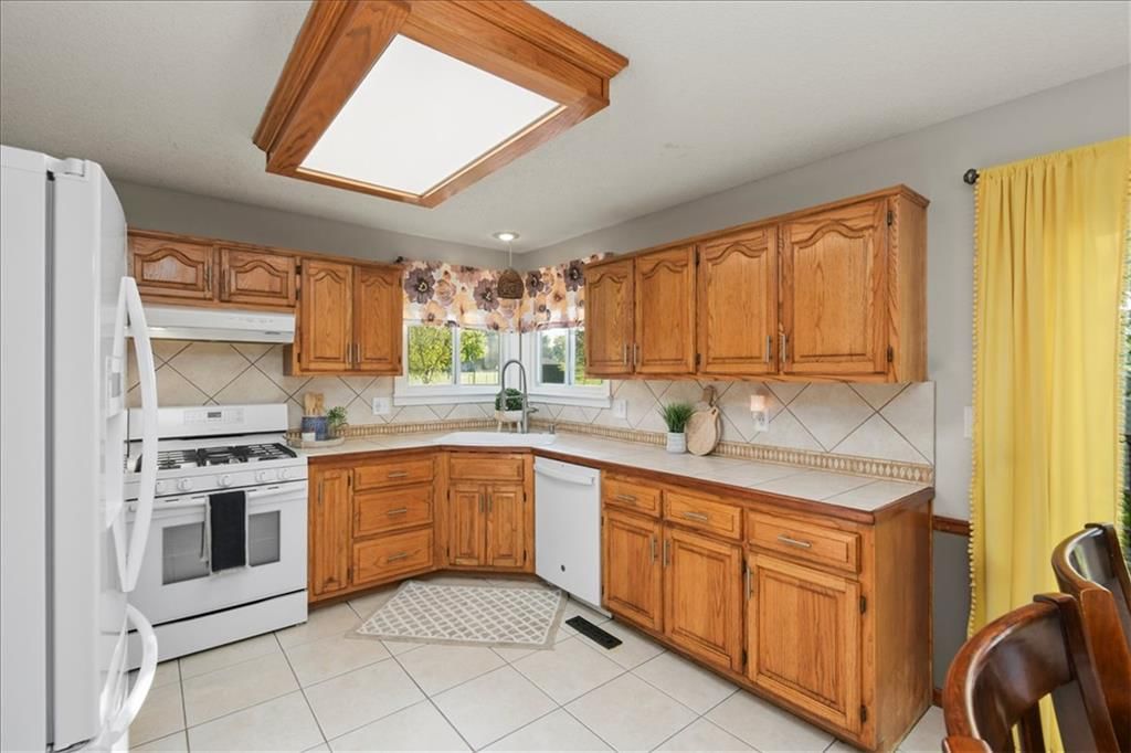 Kitchen backsplash and mixed-finish hardware at 1628 NE AUBURN Drive, Lee's Summit, MO 64086