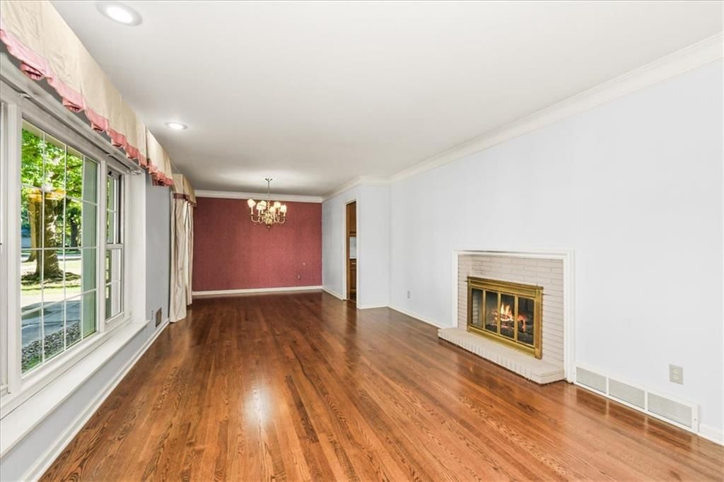 Fireplace, open floor plan and hardwood floors at 11000 Washington Street, Kansas City, MO 64114