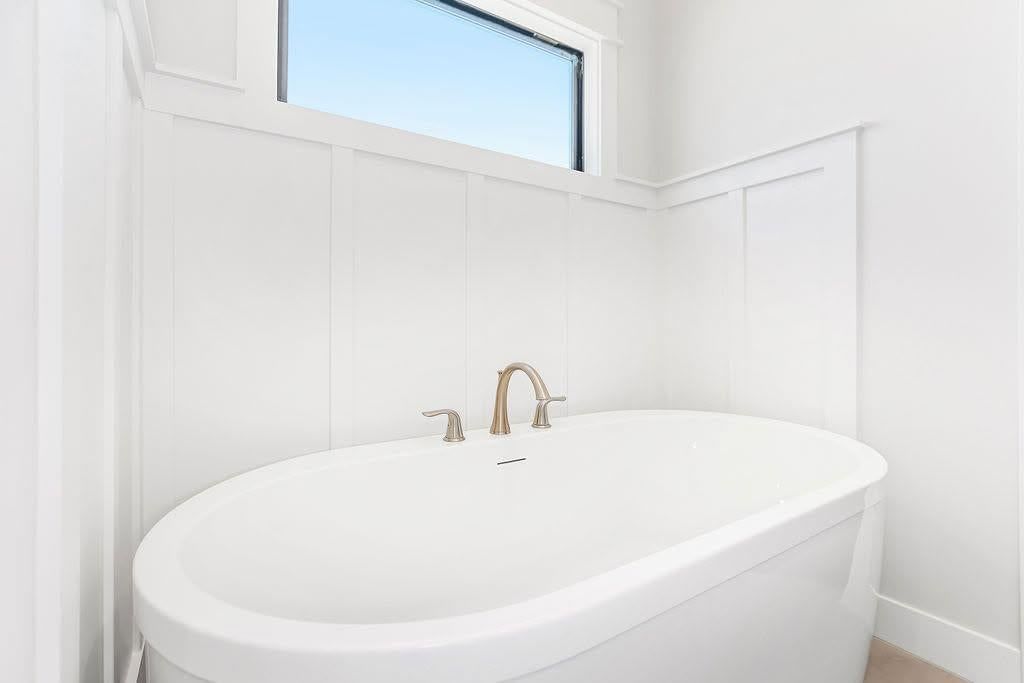Freestanding tub and renovated bathrooms at 2313 Larkspur Lane, Kearney, MO 64060