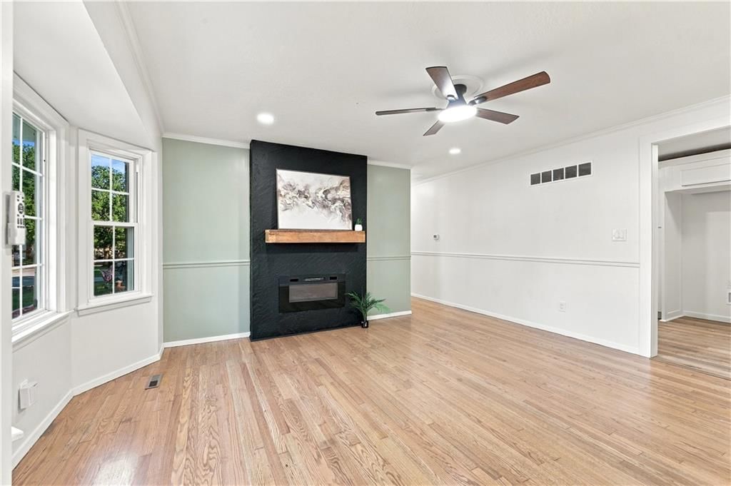 Fireplace, open floor plan and main-floor primary bedroom at 15401 E 36th Street S, Independence, MO 64055