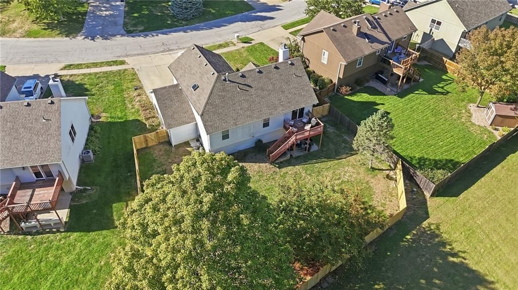 Big backyard, fenced yard and mature trees at 337 NE Dreamweaver Avenue, Lee's Summit, MO 64086