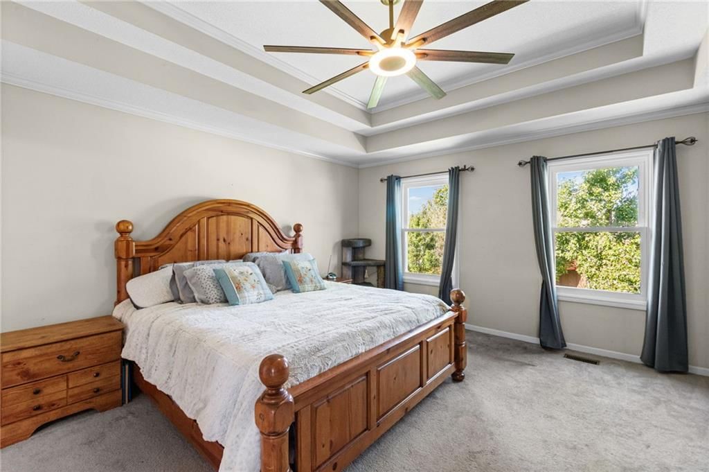 Main-floor primary bedroom and tray ceiling at 13470 Timber Park Lane, Platte City, MO 64079