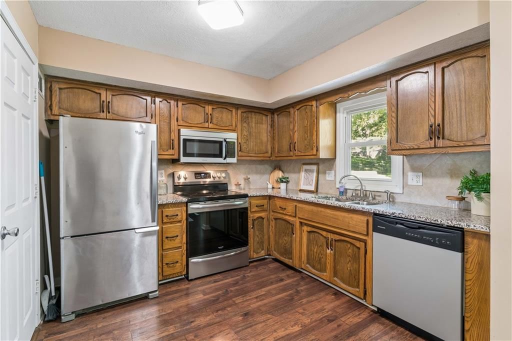 Open floor plan, granite counters and stainless steel appliances at 700 NE 55TH Street, Kansas City, MO 64118