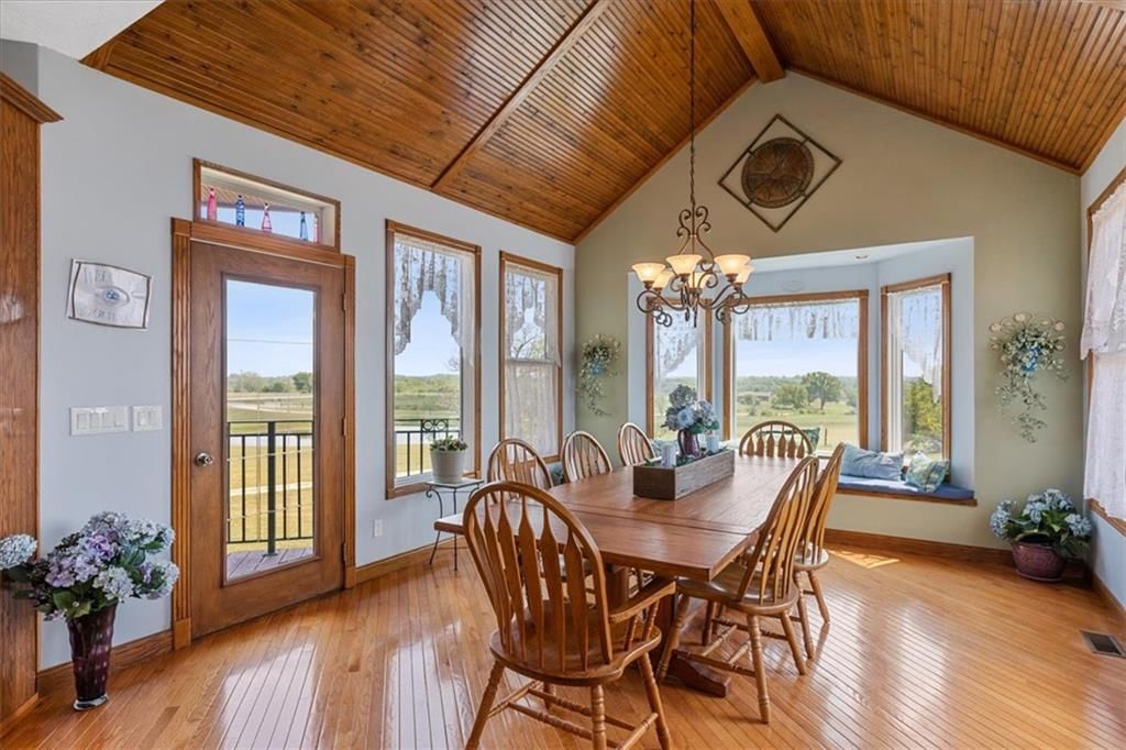 Tall ceilings, statement lighting and wall of windows at 25400 S State Route M, Garden City, MO 64747