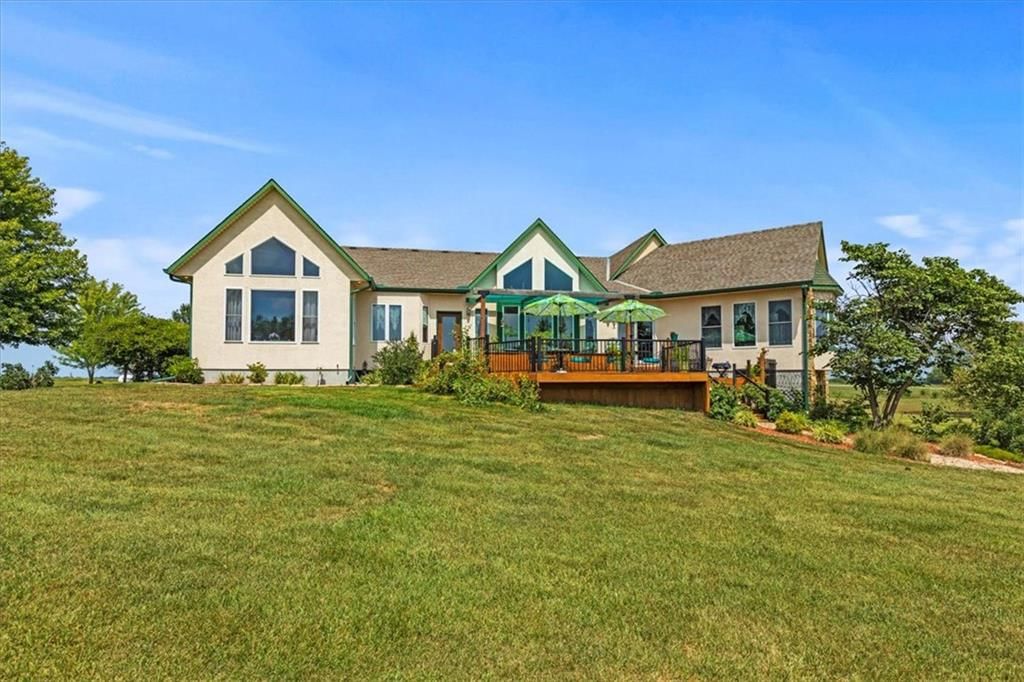 Deck, big backyard and mature trees at 25400 S State Route M, Garden City, MO 64747