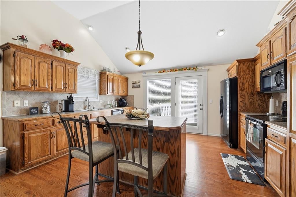 Kitchen island, kitchen backsplash and recessed lighting at 6211 NE 119th Terrace, Kansas City, MO 64156