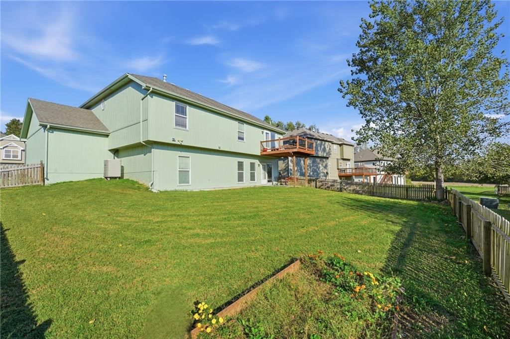 Deck, big backyard and fenced yard at 6211 NE 119th Terrace, Kansas City, MO 64156