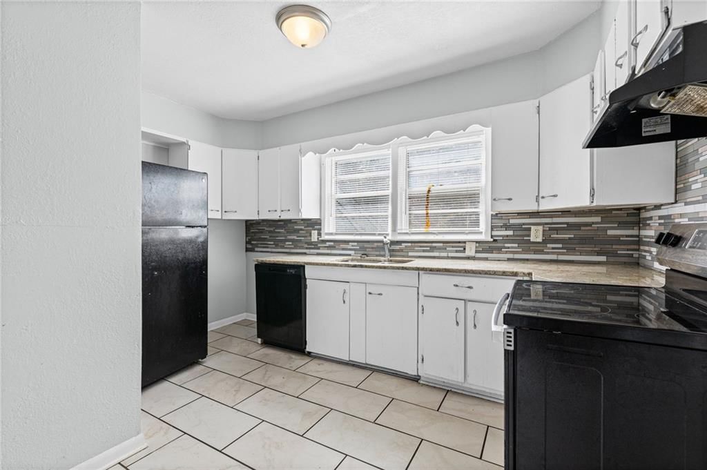 White kitchen, kitchen backsplash and mosaic tile backsplash at 10137 E 80th Street, Raytown, MO 64138