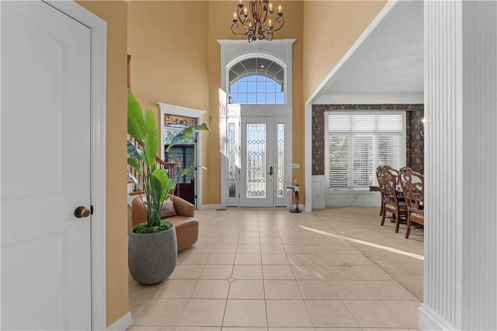 Statement lighting, tile floors and white trim at 311 NW Rockwood Court, Lee's Summit, MO 64081