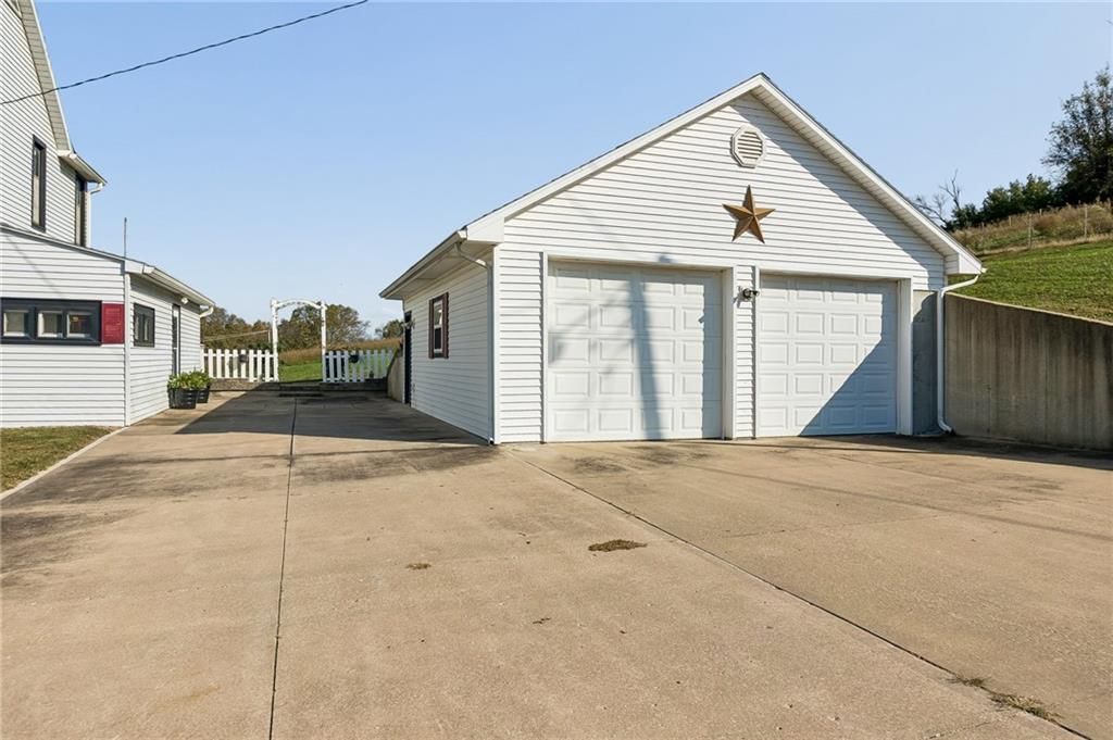 Fenced yard, concrete driveway and concrete patio at 26876 Tonganoxie Drive, Leavenworth, KS 66048