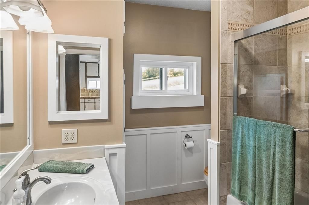 Wainscoting or board and batten and tiled shower at 26876 Tonganoxie Drive, Leavenworth, KS 66048