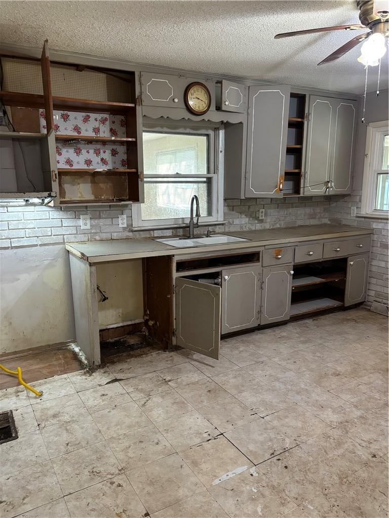 Gray kitchen cabinets and kitchen backsplash at 11231 E 14th Street S, Independence, MO 64052