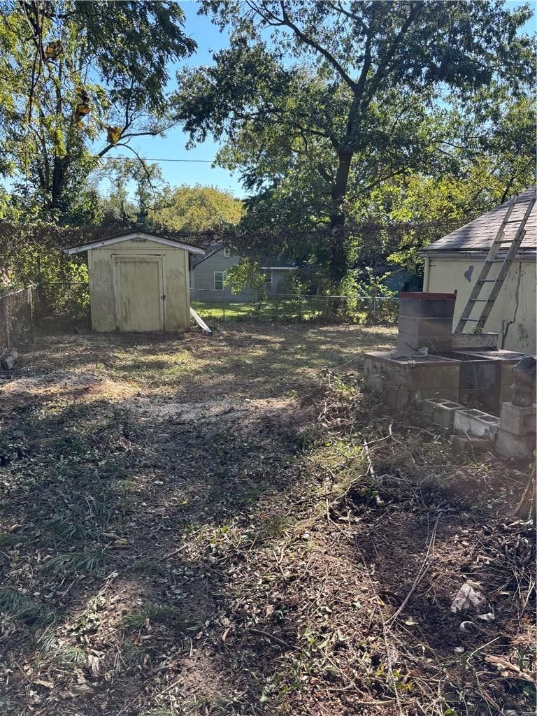Fenced yard, mature trees and flat lot at 11231 E 14th Street S, Independence, MO 64052