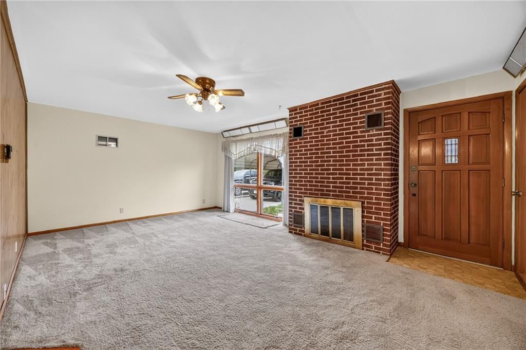 Fireplace, main-floor primary bedroom and exposed brick wall at 29602 D Highway, Lawson, MO 64062