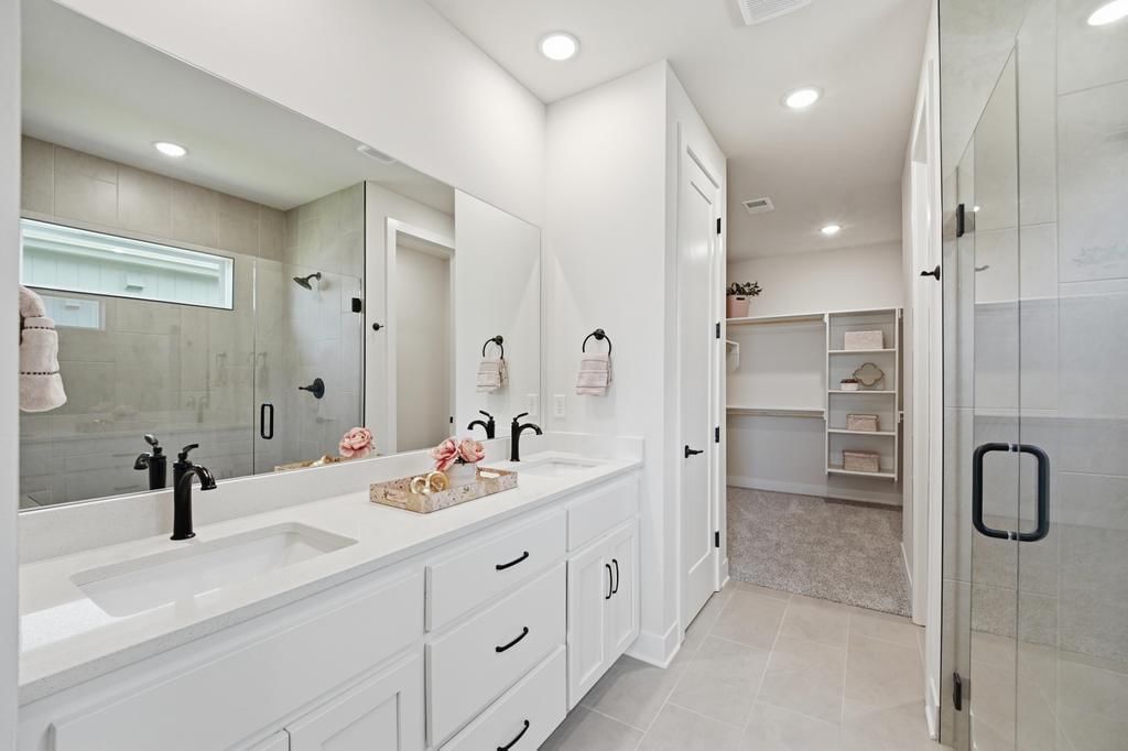 Walk-in shower, tiled shower and double vanity at 17690 Jubilee Street, Gardner, KS 66030