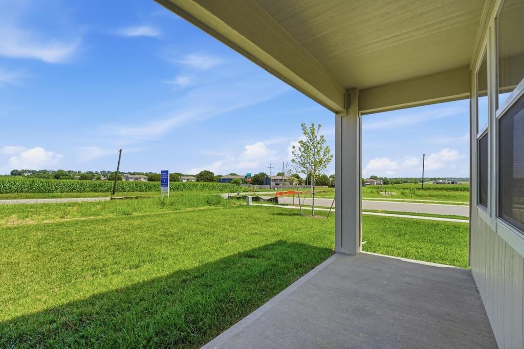Covered front porch, corner lot and covered patio at 17690 Jubilee Street, Gardner, KS 66030