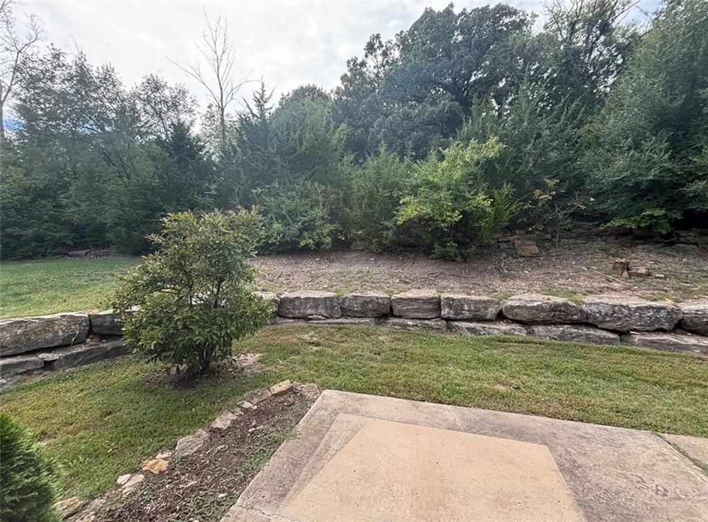 Mature trees, fire pit and concrete patio at 7826 Mullen, Lenexa, KS 66216