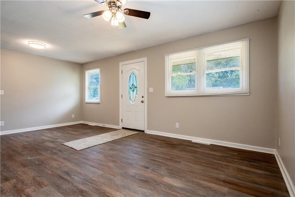 Main-floor primary bedroom, luxury vinyl floors and white trim at 5126 N Corrington Avenue, Kansas City, MO 64119