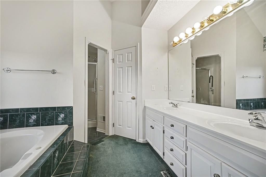 Double vanity and white vanity at 24909 E Blue Mills Road, Independence, MO 64058