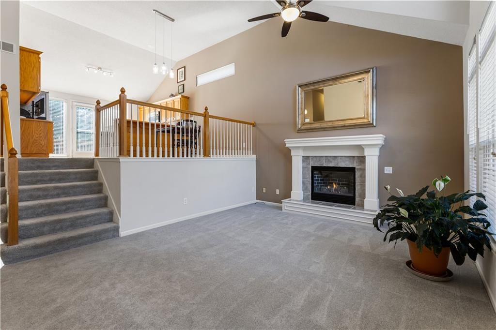 Fireplace, staircase and wood stair railing at 23707 W 58th Terrace, Shawnee, KS 66226