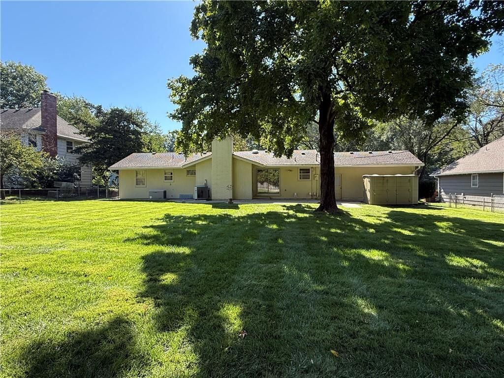 Big backyard, mature trees and concrete patio at 4100 W 100th Terrace, Overland Park, KS 66207