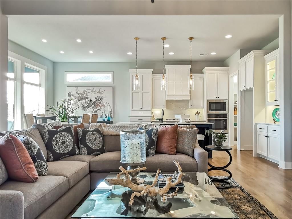 Kitchen island, quartz counters and gas range at 10514 N Olive Court, Kansas City, MO 64155