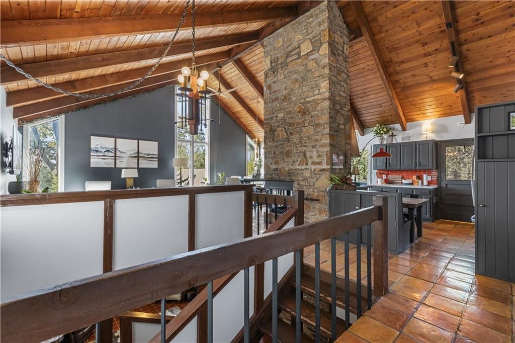 Tall ceilings, exposed brick wall and statement lighting at 21018 BITTERSWEET Drive, Lenexa, KS 66220