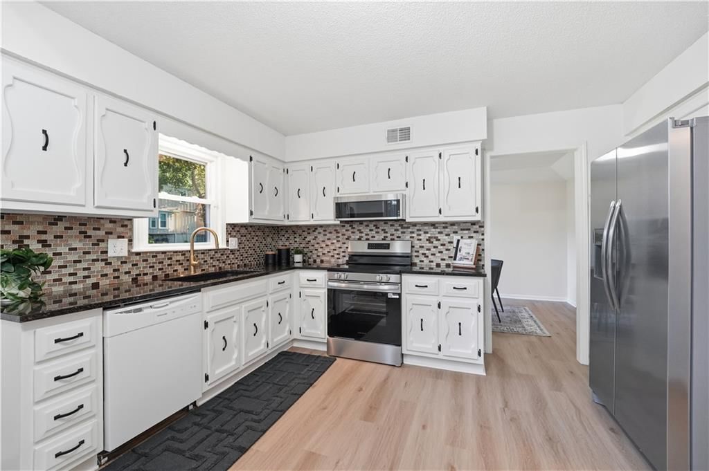 Photo 8: white kitchen cabinets, 2004 E 144th Terrace, Olathe, KS 66062