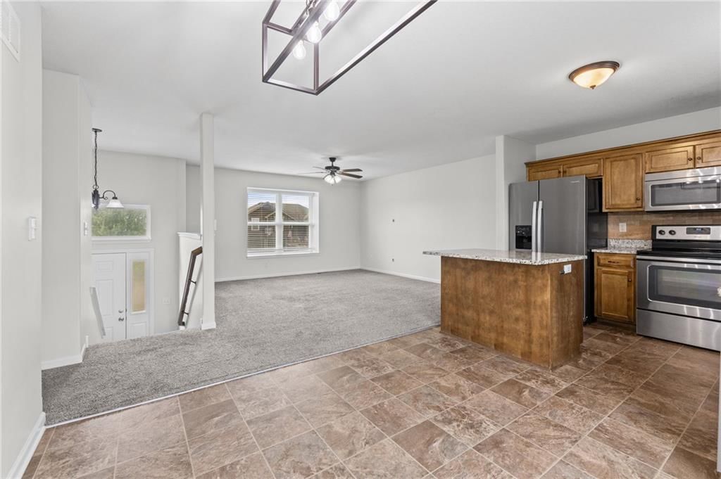 Granite counters, stainless steel appliances and electric range at 502 193rd Street, Smithville, MO 64089