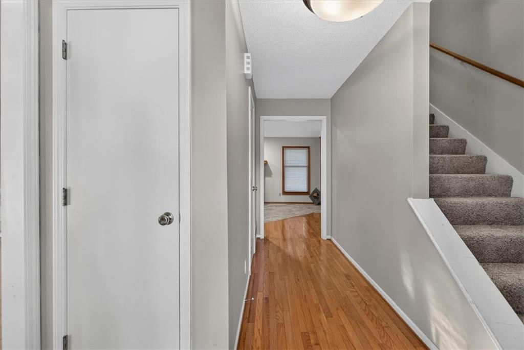 Staircase and wood stair railing at 10228 Caenen Drive, Lenexa, KS 66215