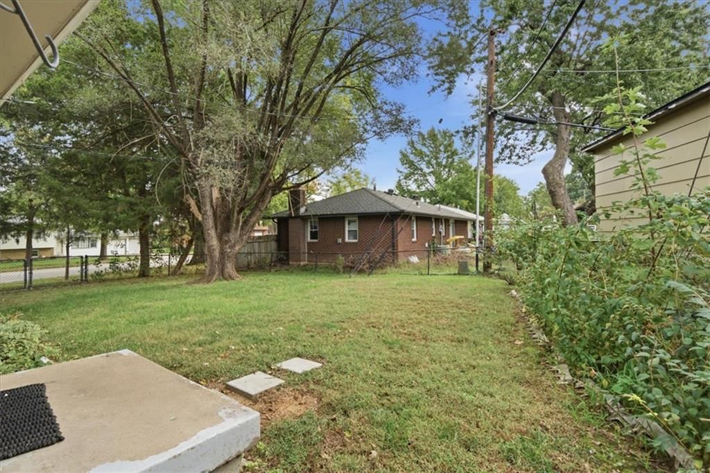 Fenced yard, chain-link fence and concrete patio at 3501 Woodbury Street, Independence, MO 64055