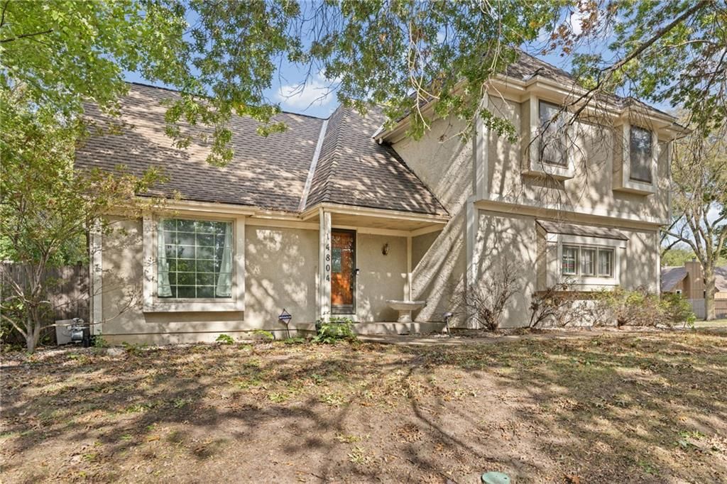 Covered front porch, corner lot and mature trees at 14804 W 84th Terrace, Lenexa, KS 66215
