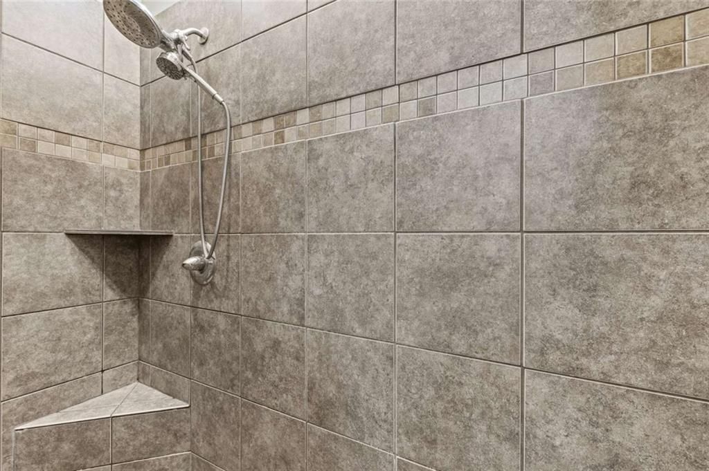 Walk-in shower and tiled shower at 211 Surrey Court, Smithville, MO 64089