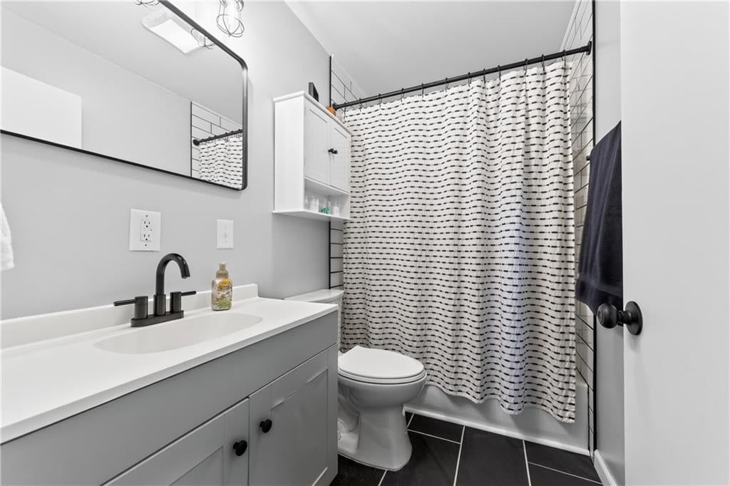 Gray vanity and black hardware at 114 W 8th Street, Kearney, MO 64060