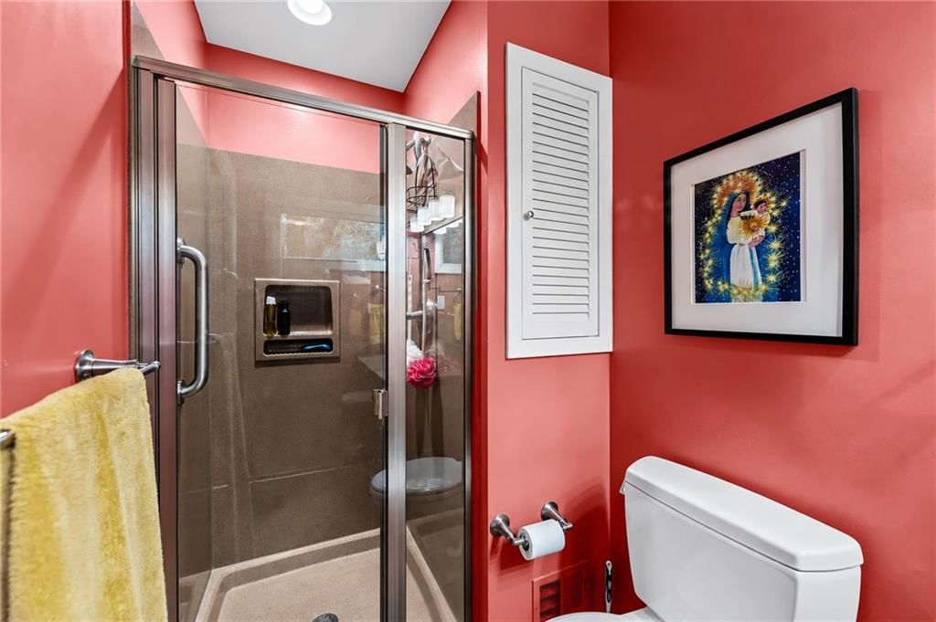 Tiled shower and frameless glass shower at 6527 Maple Drive, Mission, KS 66202